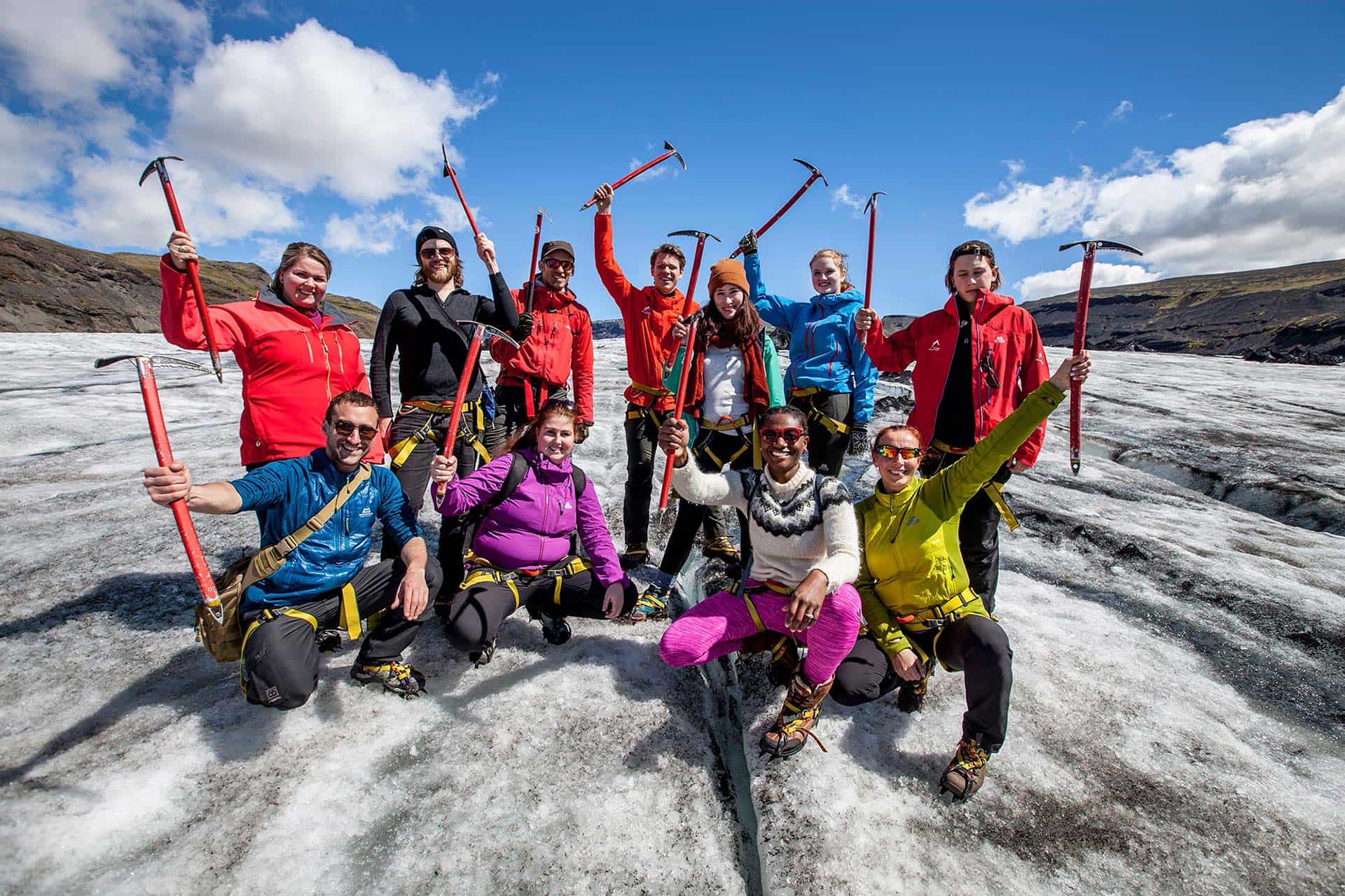 Group of hikers with ice axes on a glacier in Iceland.