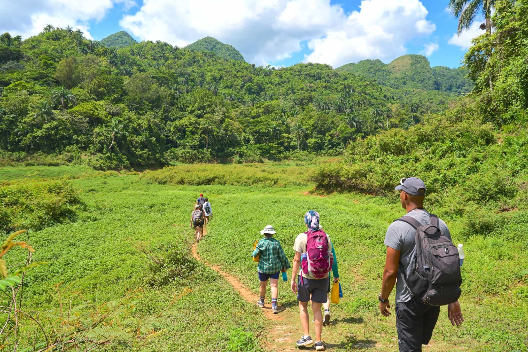 4 people hiking through El Nicho, Cuba