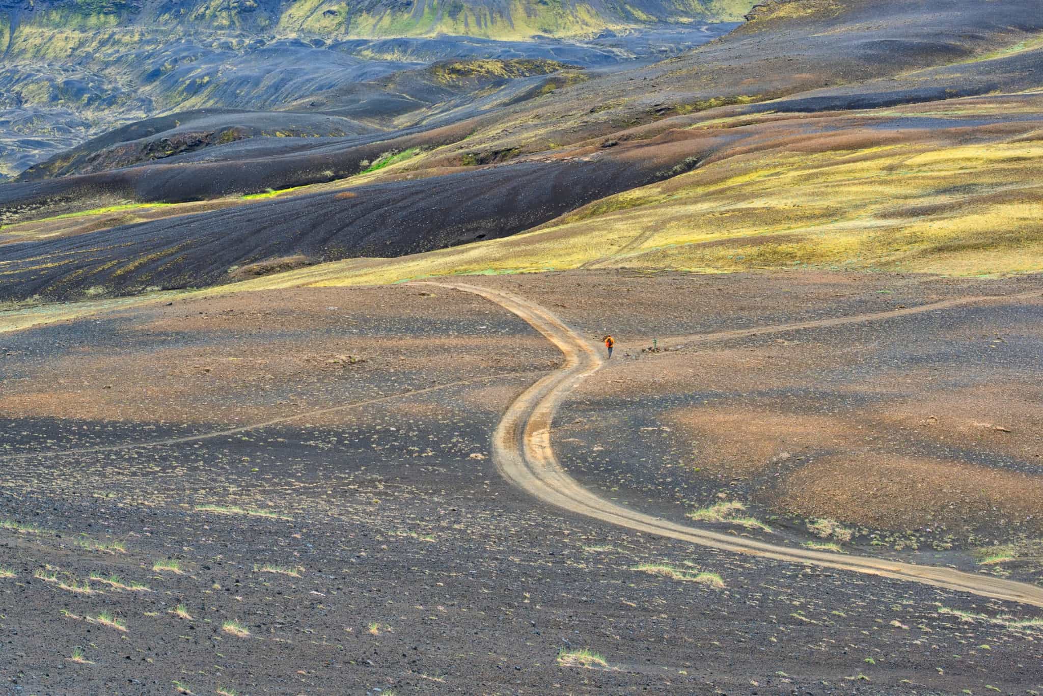 Hiker among the landscapes of Iceland on the Laugavegur Trail.