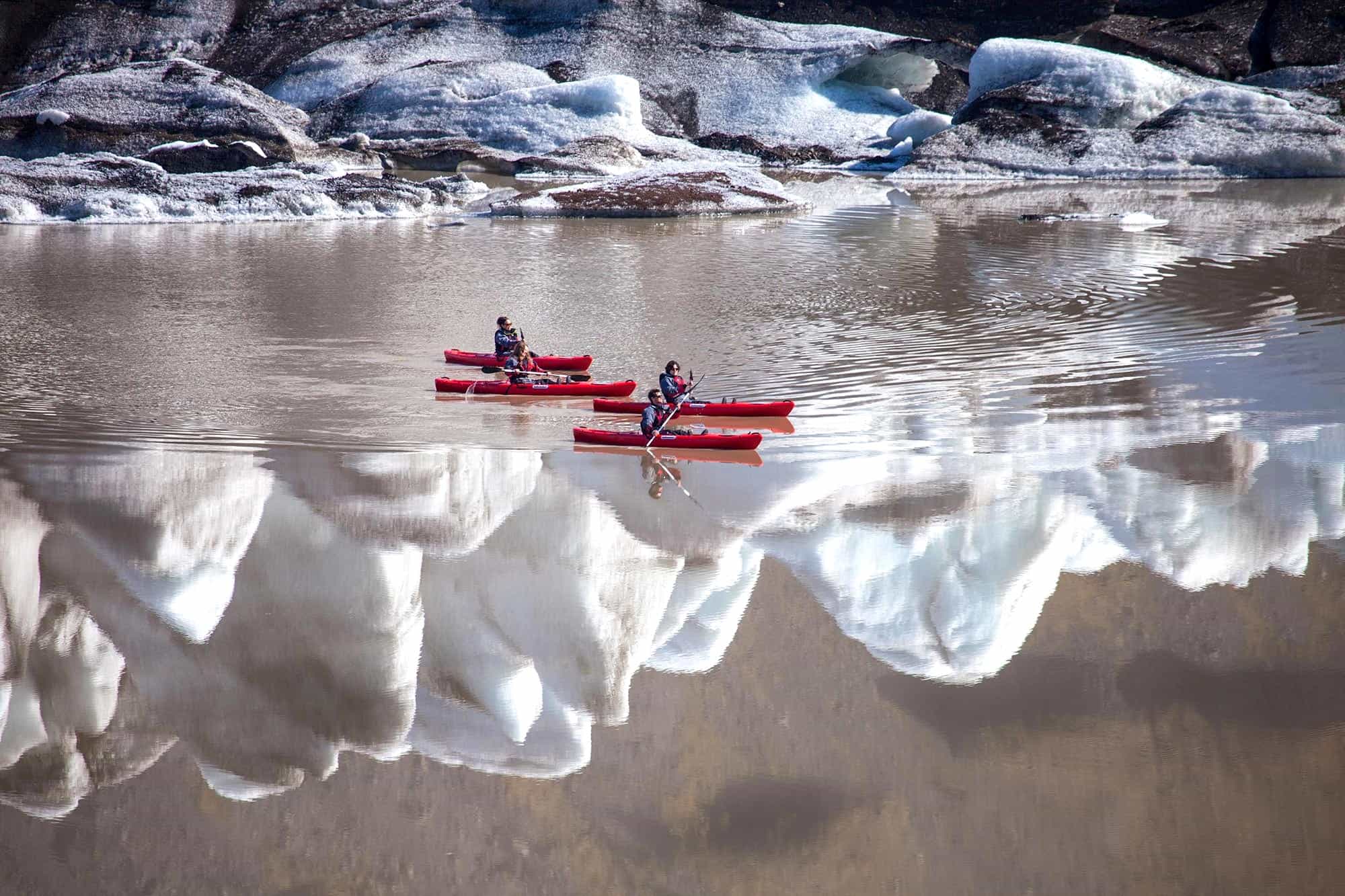 Kayakers on the lagoon at Sólheimajökull glacier, Iceland