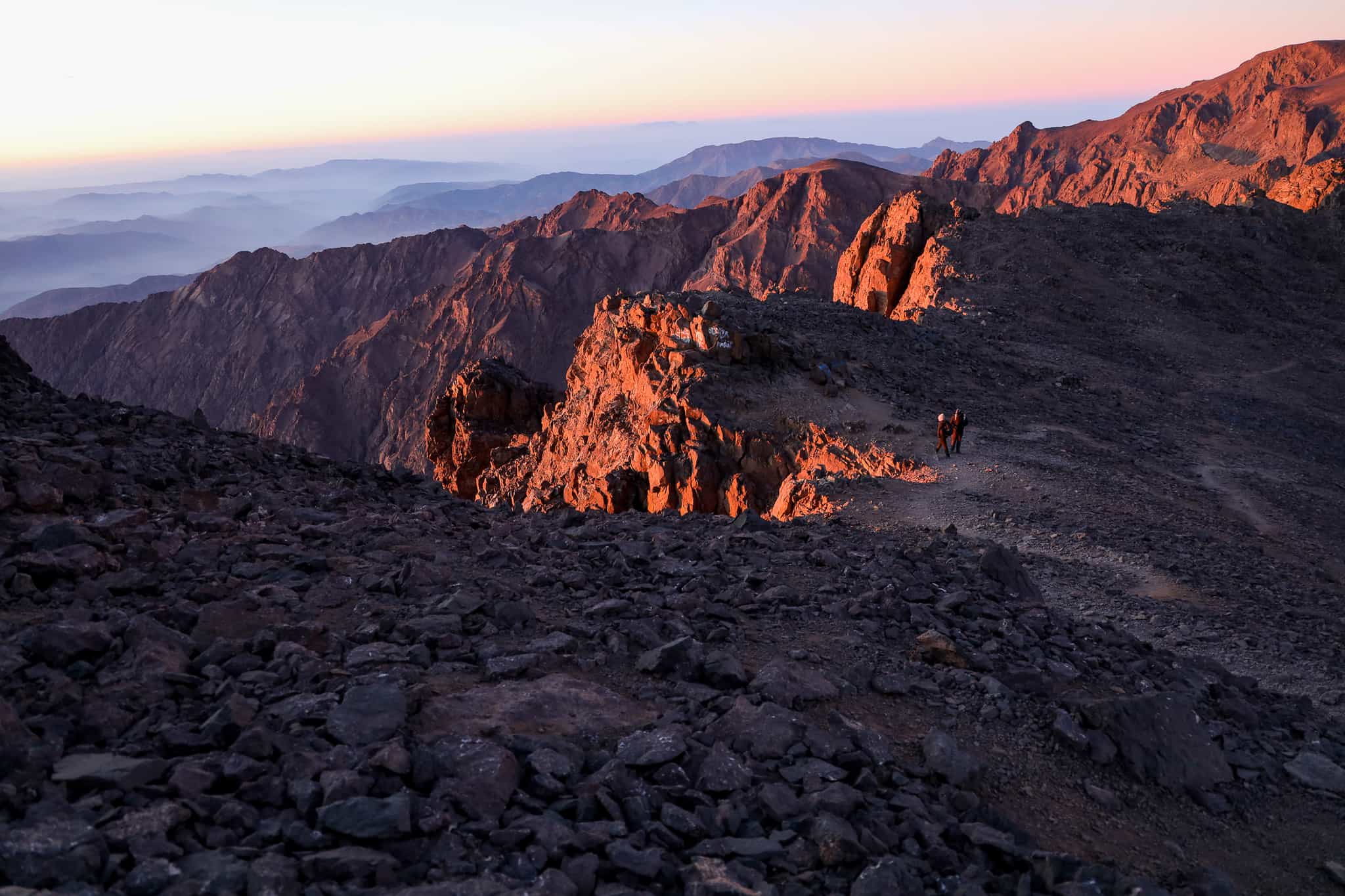 The rocky, dusty slopes of Morocco's Mount Toubkal at sunrise.