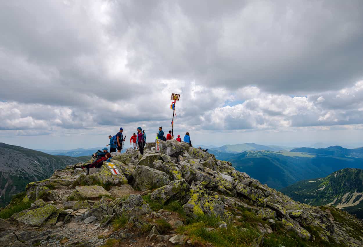 Trekkers on top of the Peak of Peleaga, Retezat Mountains, Romania.