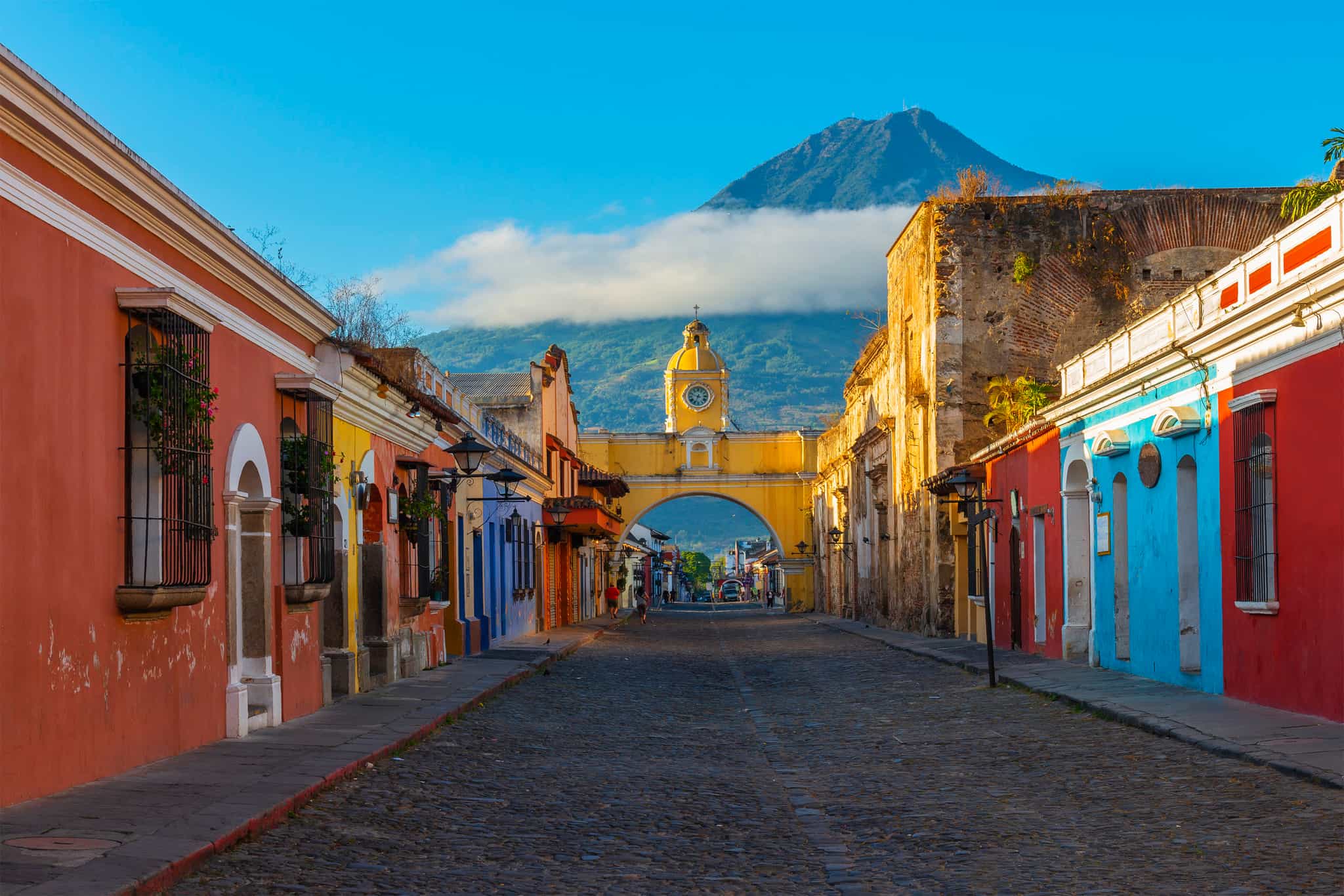 Santa Catalina arch in the historic centre of Antigua, with Agua volcano in the background, Guatemala.
