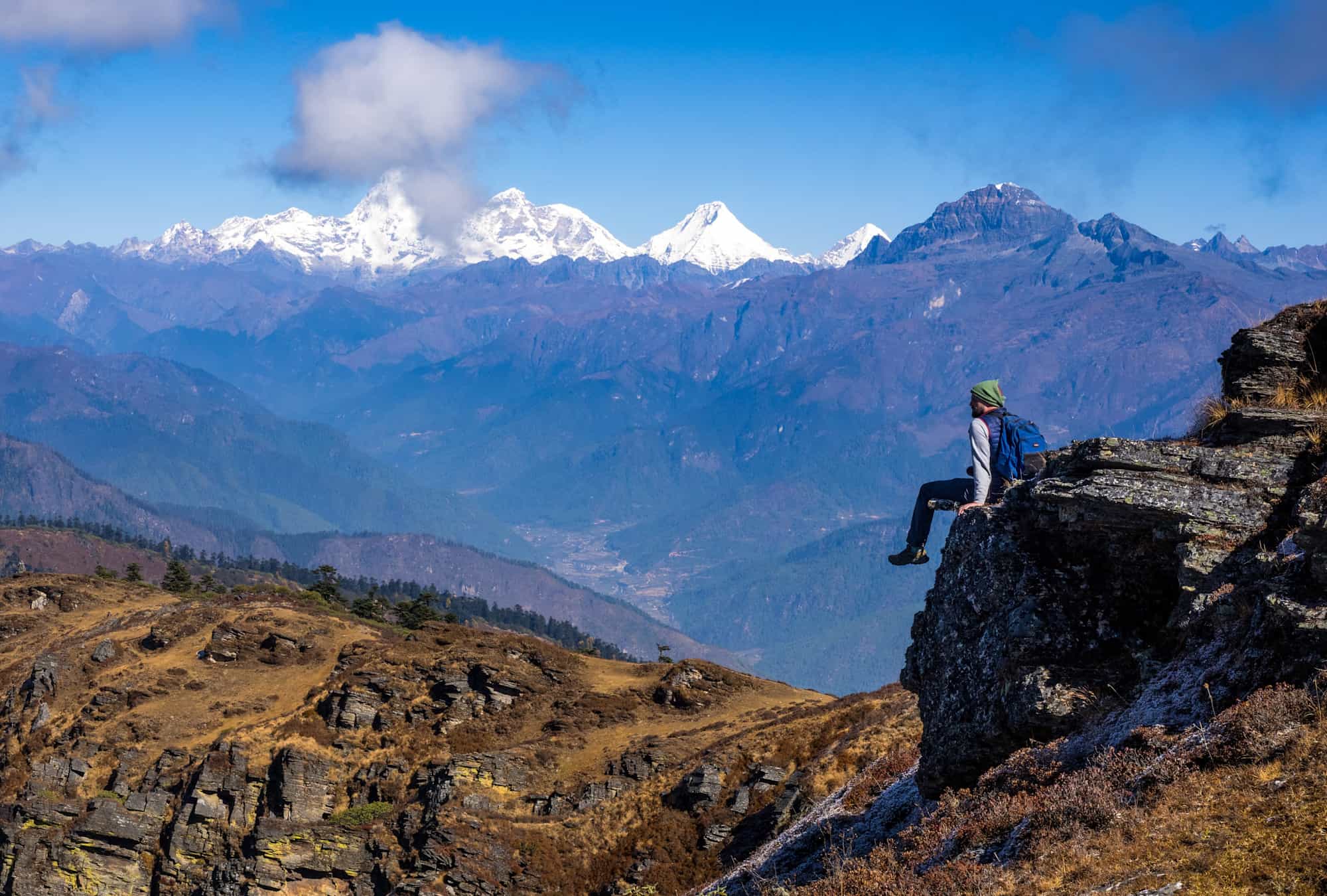 Hiker looking out towards the Himalayas from the Chele la pass, Bhutan