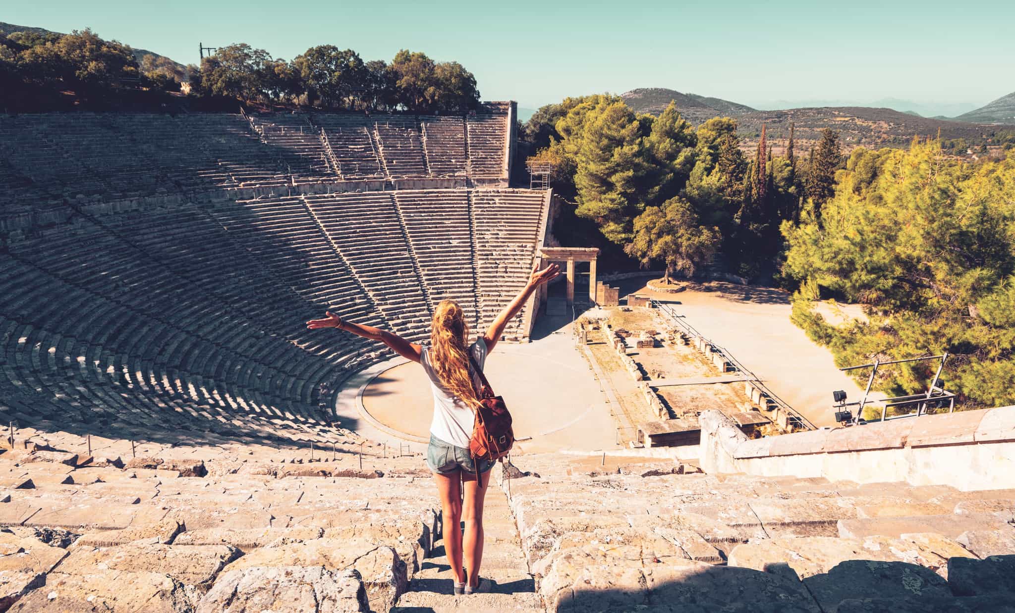 Woman looking out over Epidaurus theatre, Greece.