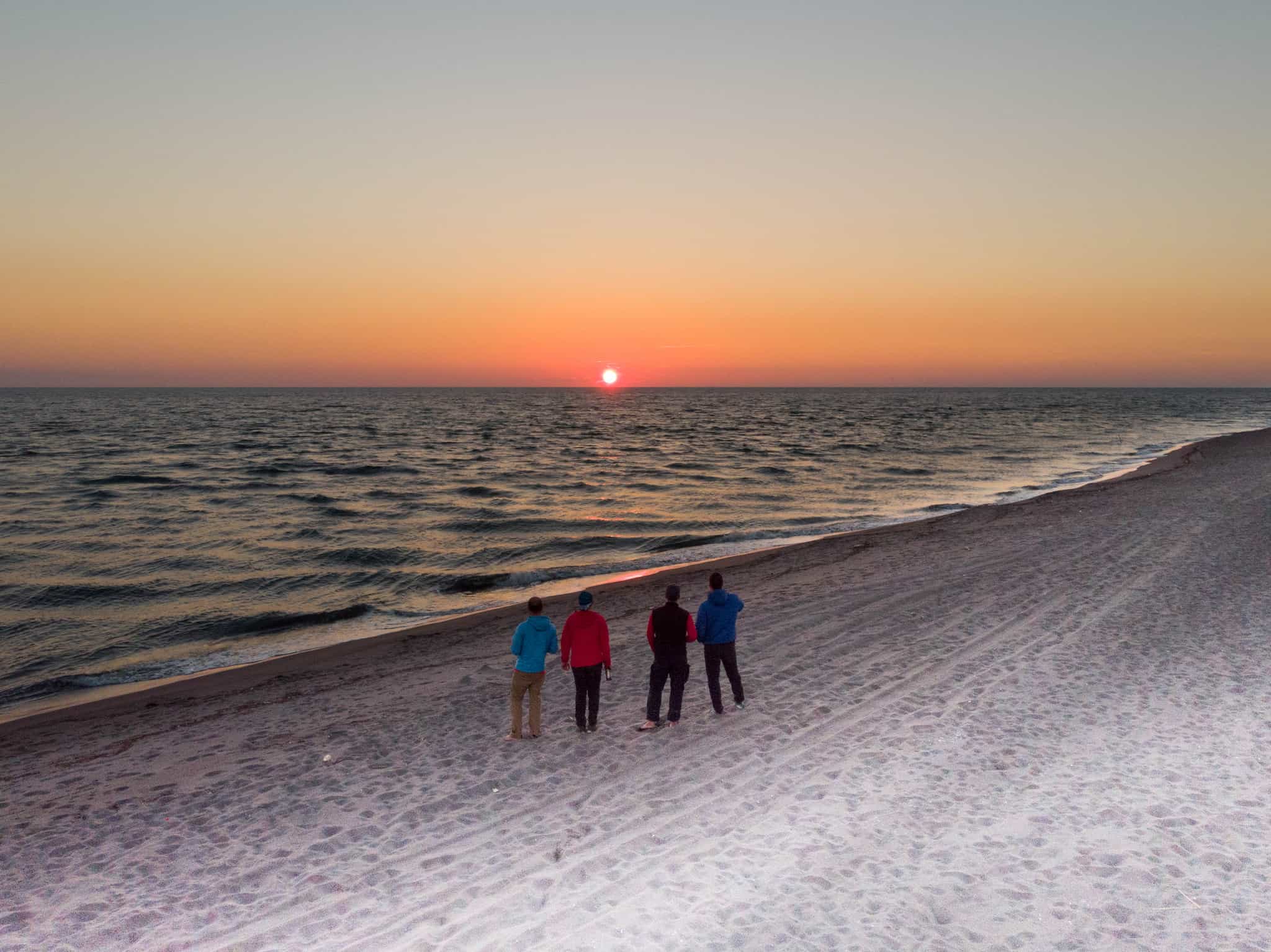 Group of adventurers looking out over the Adriatic Sea at Sunset, Montenegro.