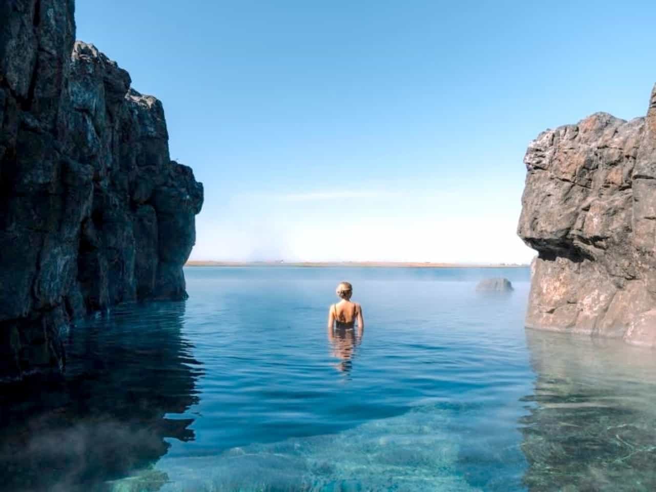 Woman bathing in a geothermal pool at the Sky Lagoon in Iceland.