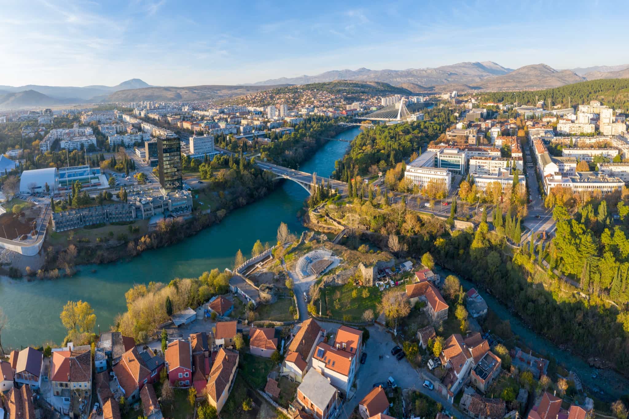 Moraca river flowing through the old town of Podgorica in Montenegro on a sunny afternoon.