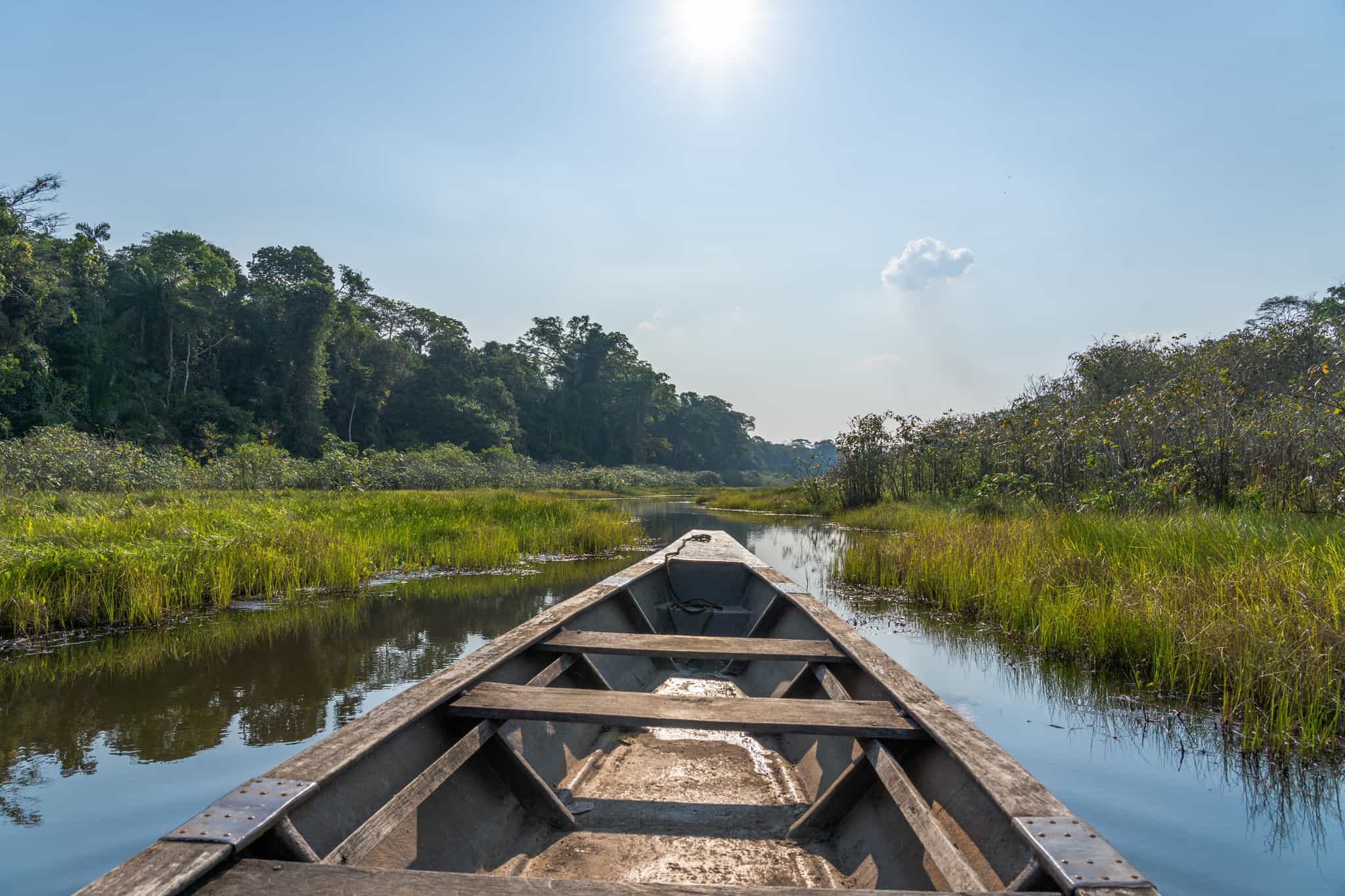 Looking out from a wooden boat on a channel through the reeds on Lake Sachavacayoc