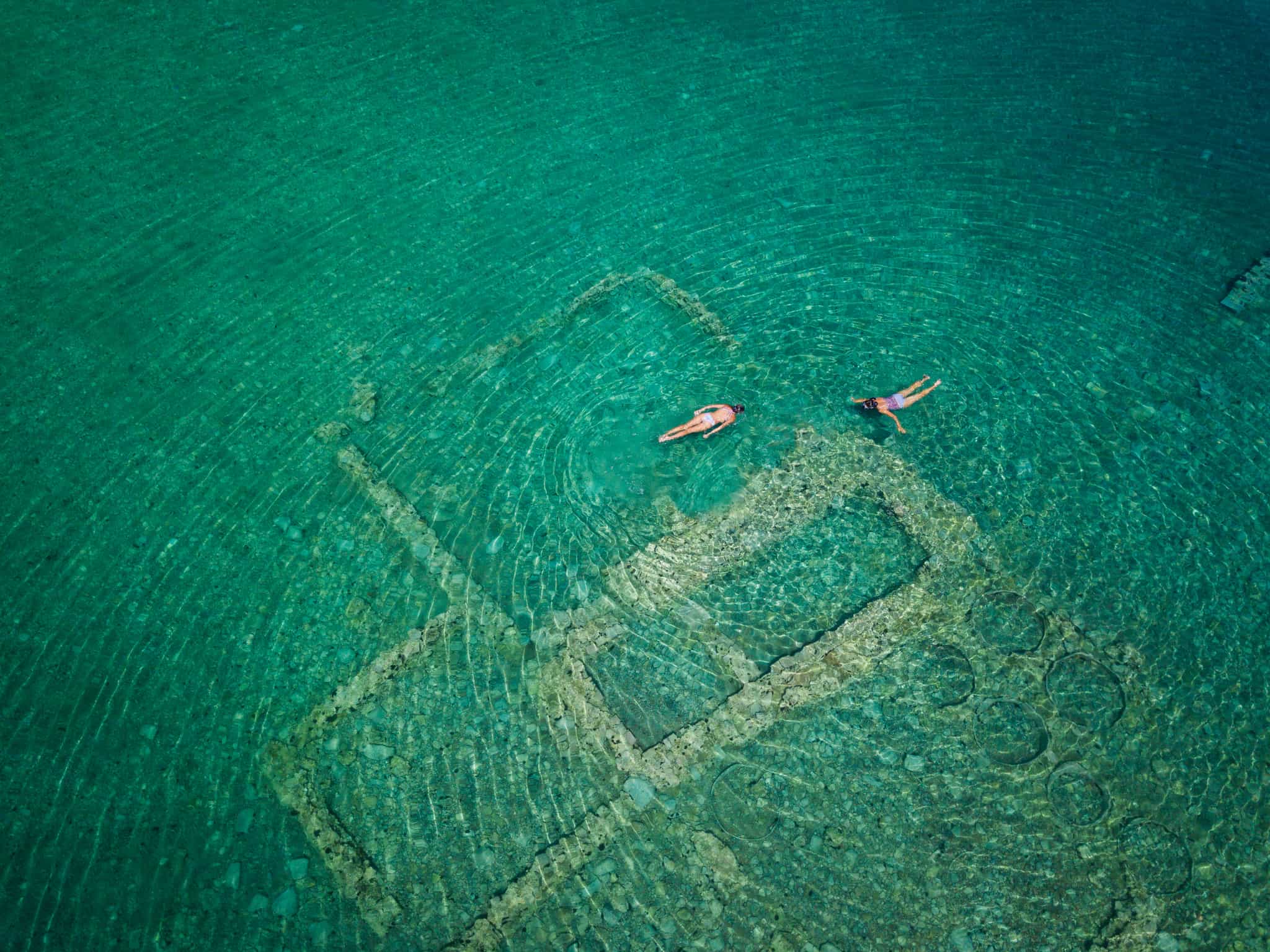 Tourists snorkelling at the sunken city of Epidaurus, Greece.