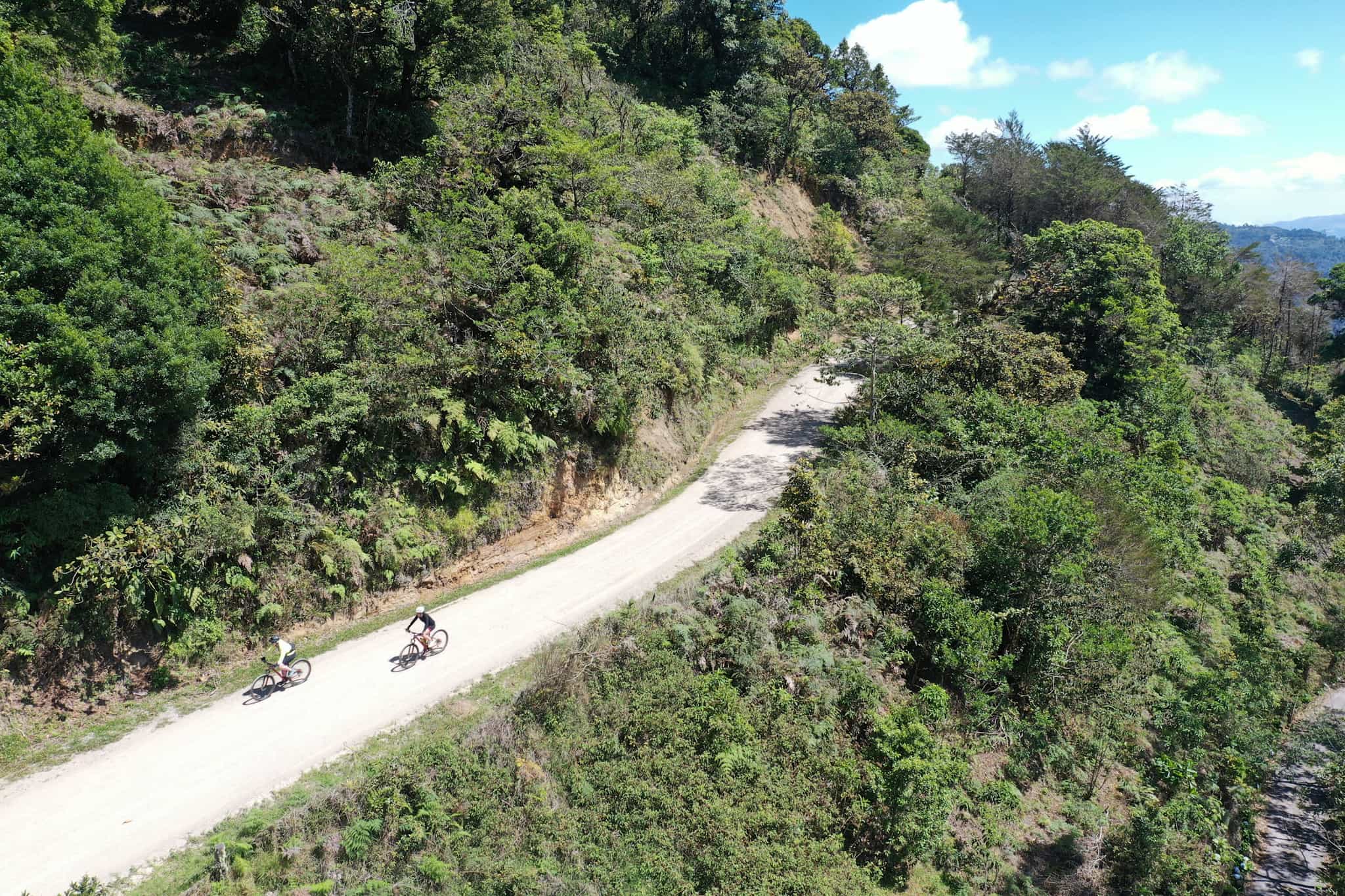 Aerial shot of cyclists on scenic road, Costa Rica