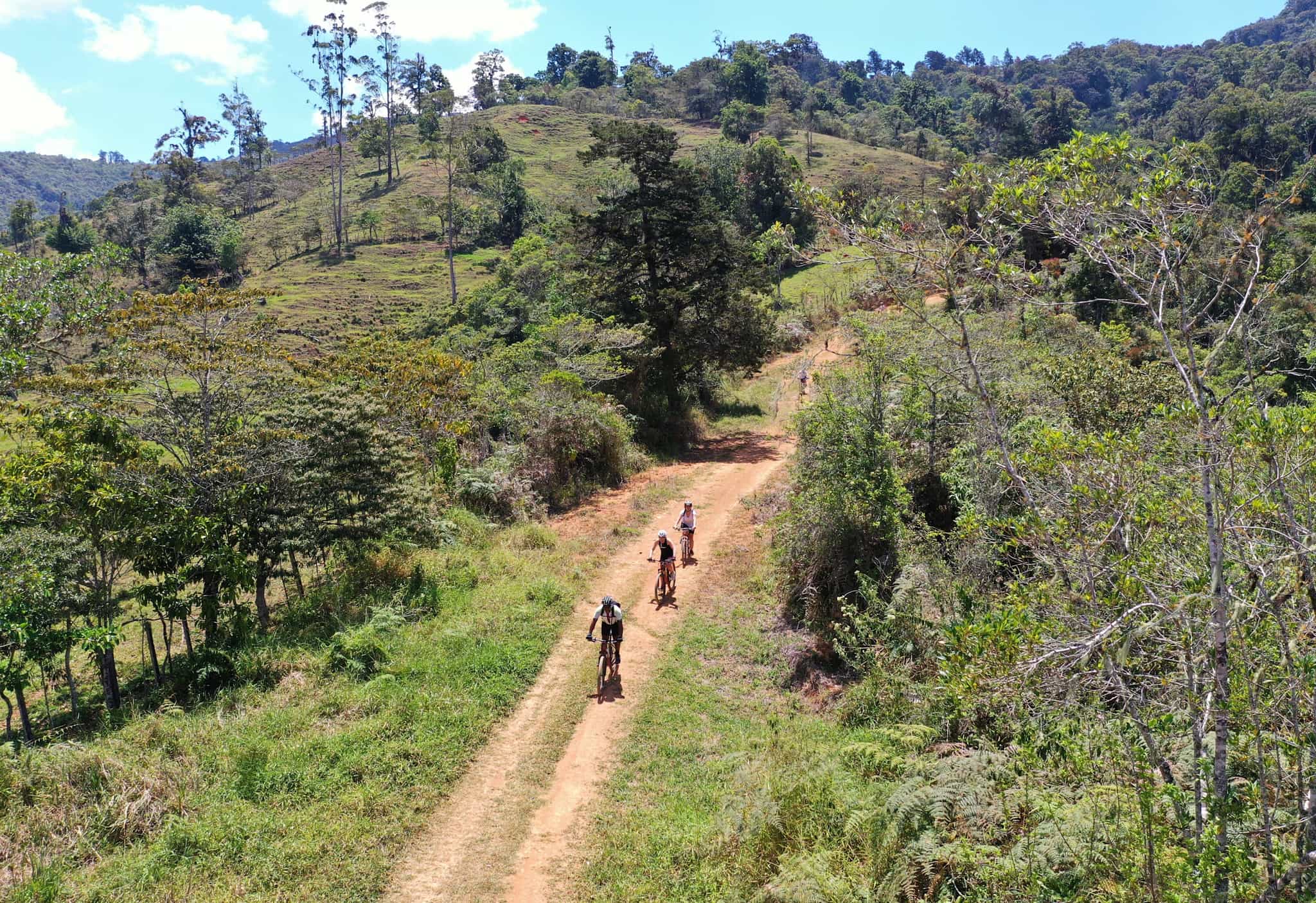 Cyclists pedalling along a track in Costa Rica